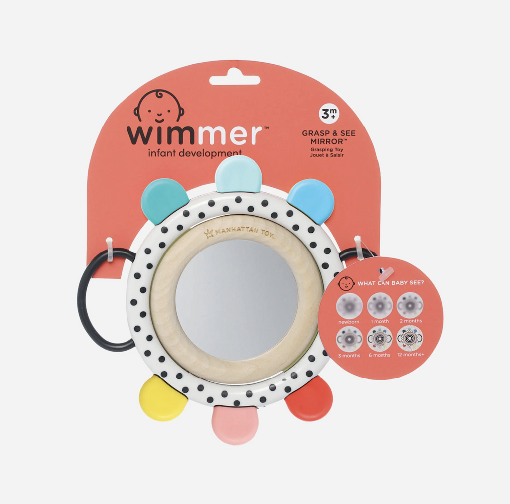 The Wimmer Grasp and See Mirror is a round baby-safe mirror, surrounded by a natural wood ring with plastic handles, and colorful soft teething nubs packaged on a hang card. 