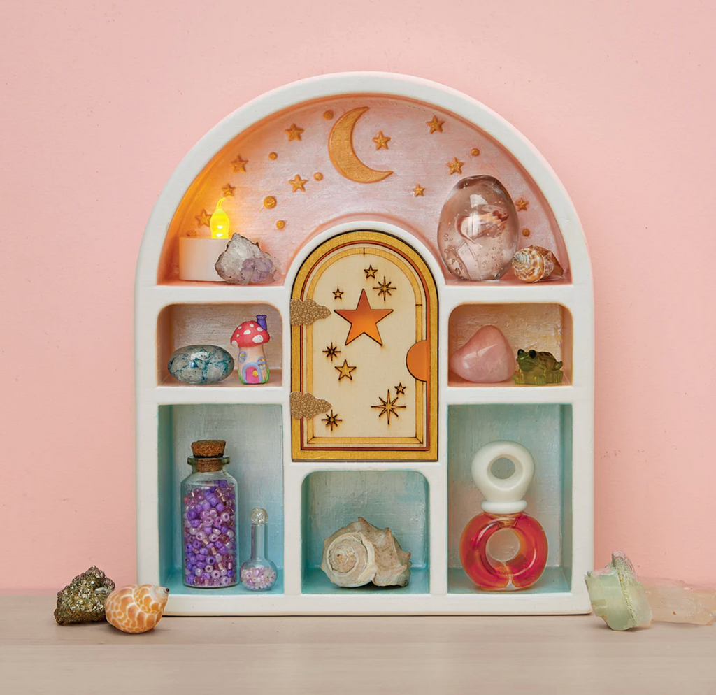 Decorative curio shelf with celestial design and various small objects painted using the Paint a Curio Shelf craft kit. 