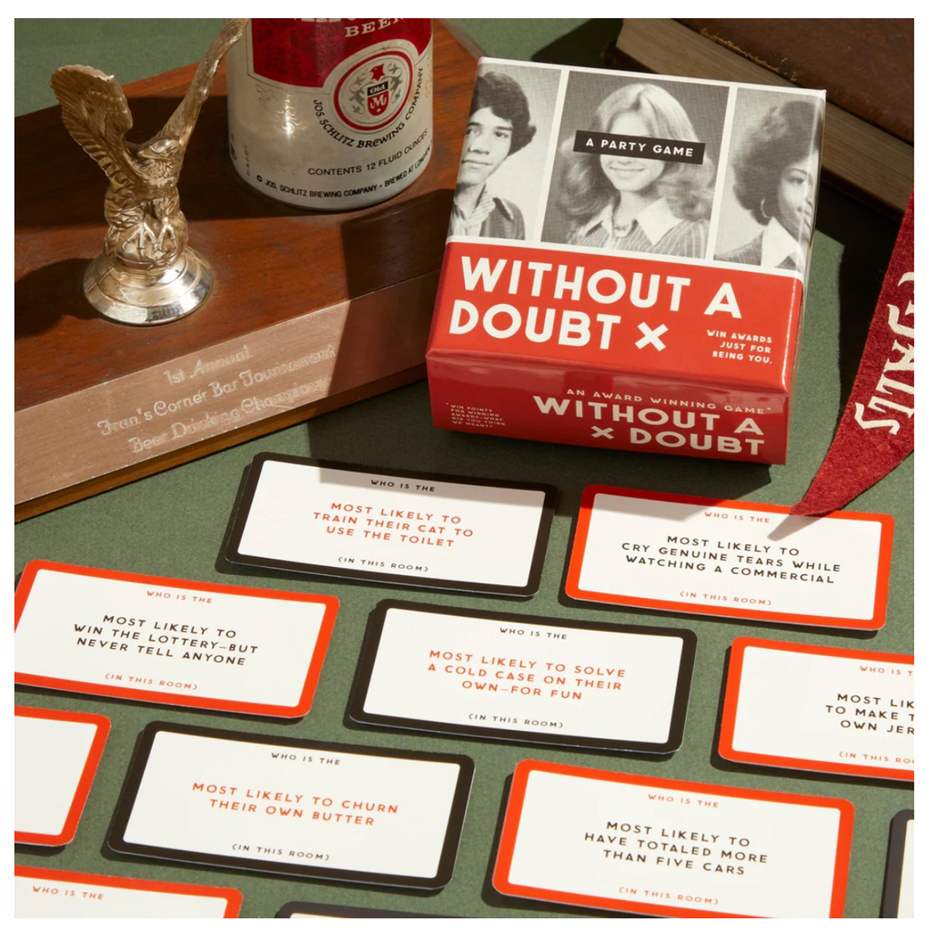 Without A Doubt game box and cards on a green table next to a sports trophy and pennant.