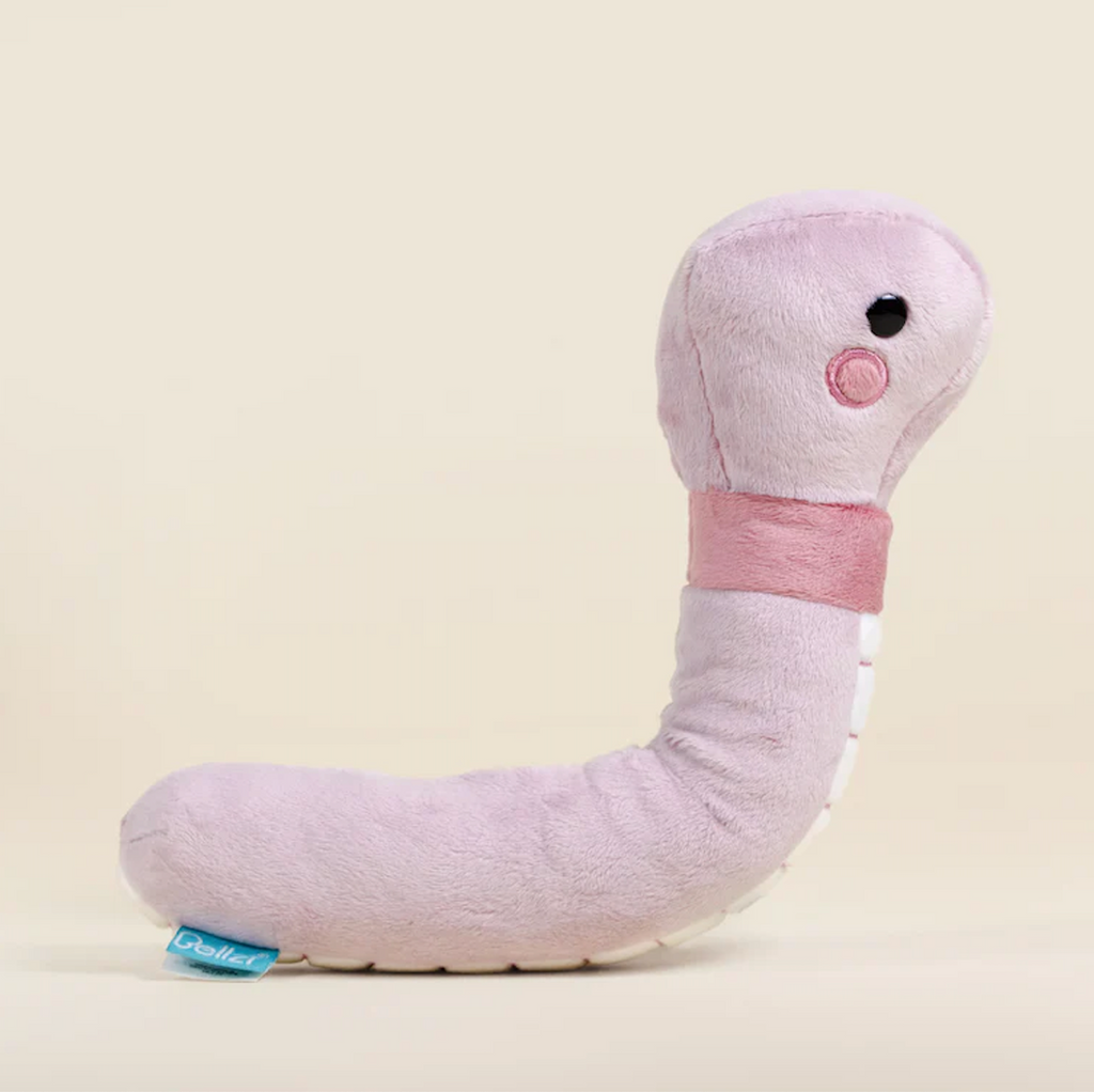 Wormi the Worm stuffed animal with pale pink plush and in  an upright pose. 