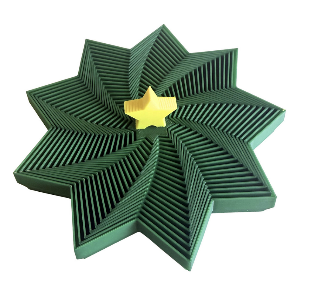 Green star shaped 3D printed fidget toy topped with a yellow star that allows you to pick up the tree and extend it to it's full height. 
