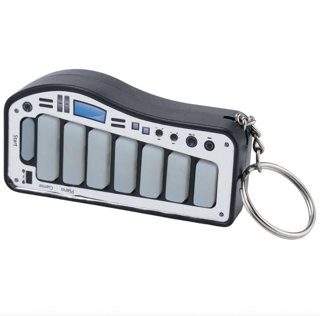 Small xylophone keyboard with keyring on a white background.