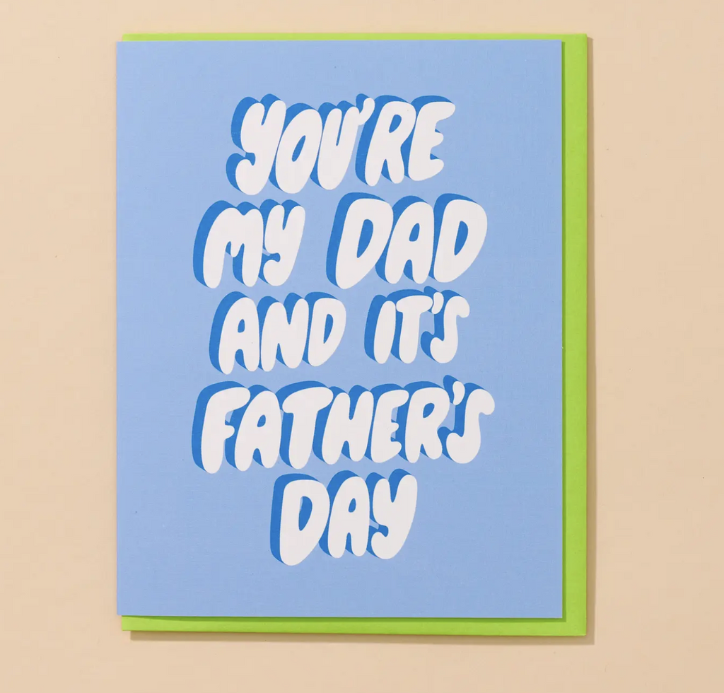 Greeting card with blue cover and white bubble letters that read " You're My Dad And It's Father's Day" 