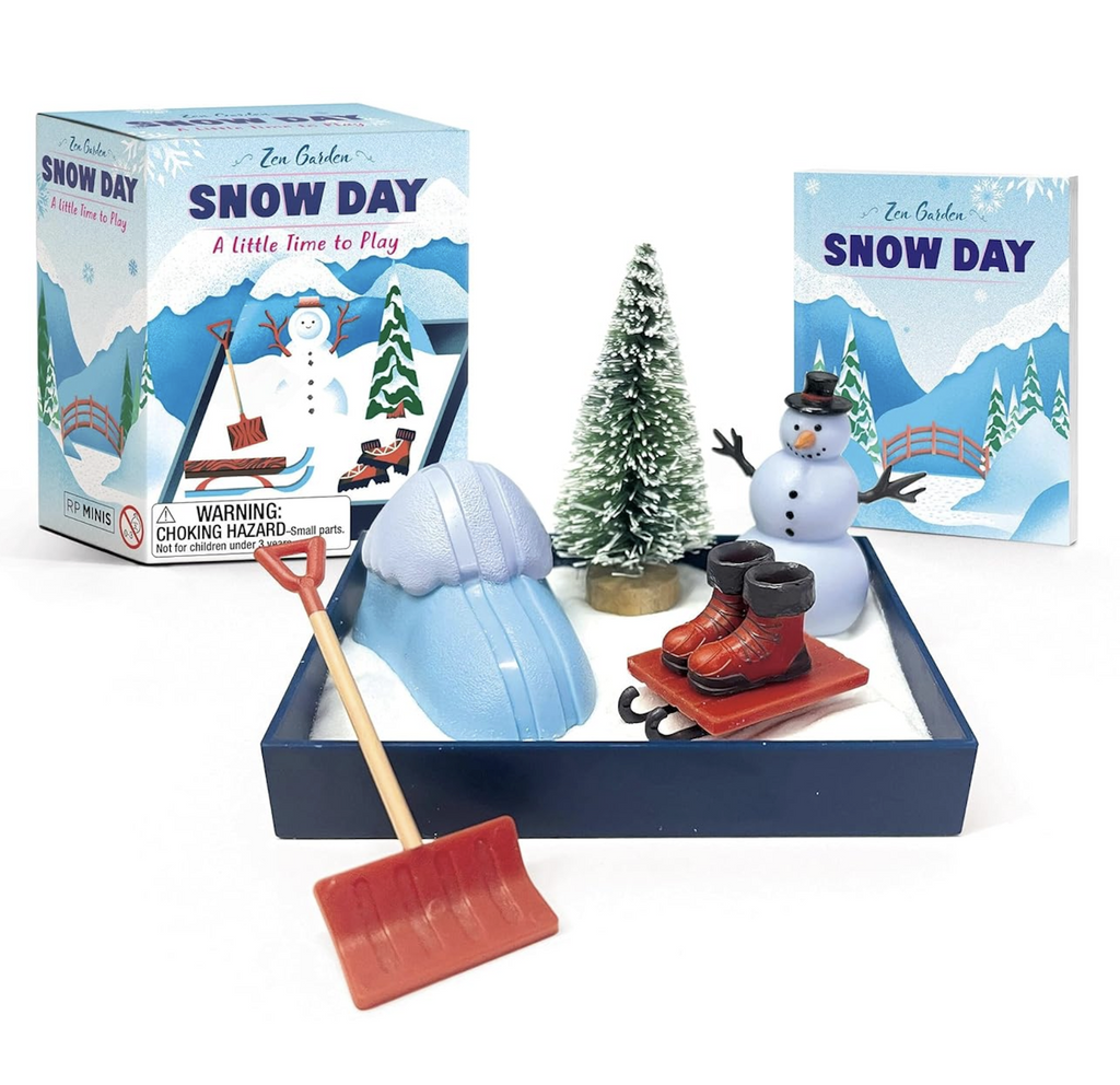 Desktop Zen Garden with white sand, snowman figure, Christmas tree, ice skates, and snow shovel along with a mini booklet. 