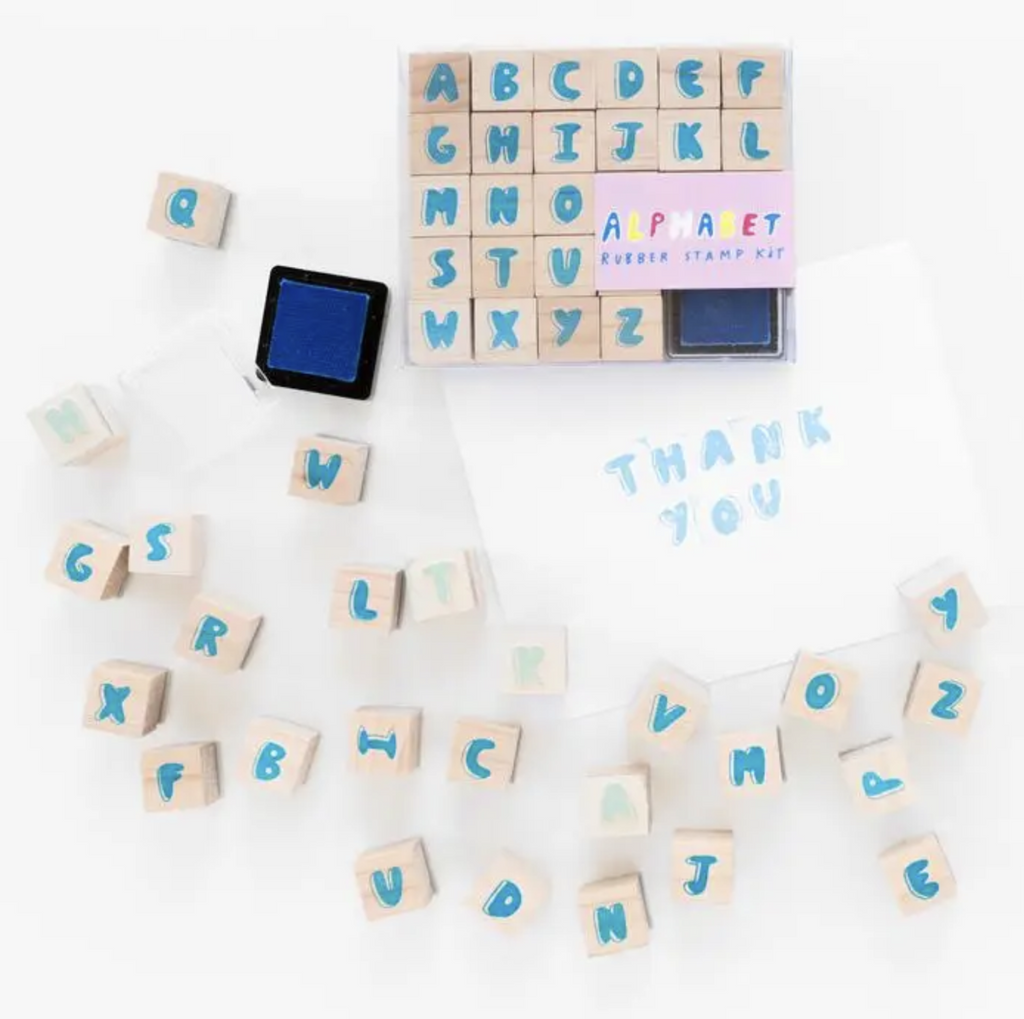 Wooden ABC rubber stamps and a blue ink pad.