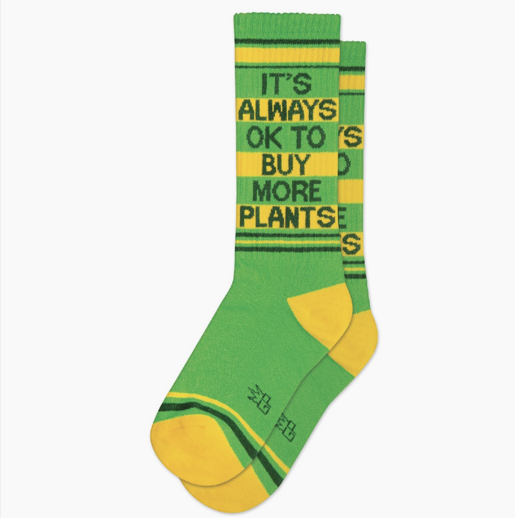 Green with yellow athletic socks that reads It's Always Ok to Buy More Plants.