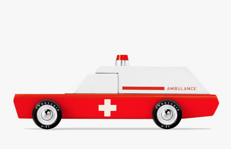 Side view of the retro Ambulance in red and white, with a red siren on the roof.
