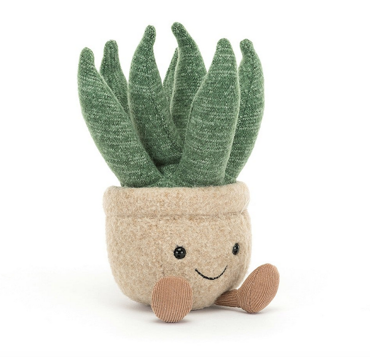 Plush potted aloe vera plant. The pot is a sandy color with brown, courduroy boots sticking out from under the pot. The leaves of the aloe plant are sticking up in a light green knit. 