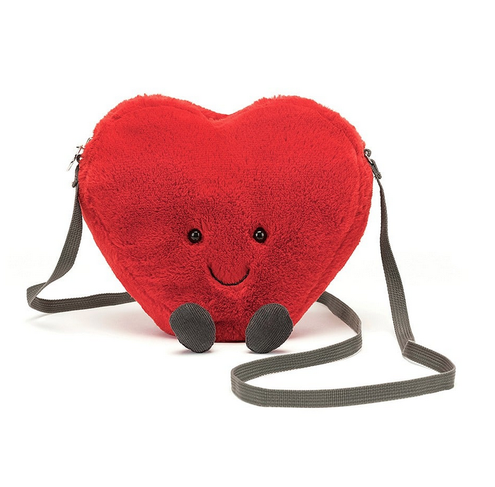 The Amuseable Heart Plush Bag in a seated position with it's red plush body and shoulder strap. 
