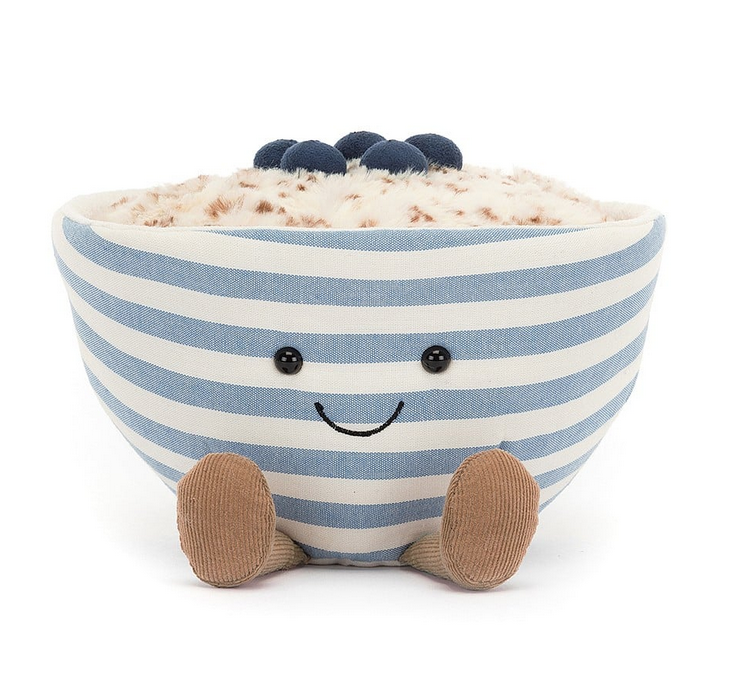 A blue and white smiling, striped bowl with light brown feet stuck out in front. With blueberries resting atop a bowl full of golden brown oatmeal. 