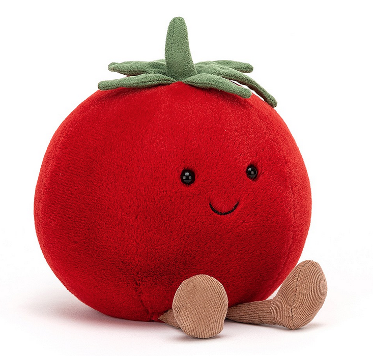 Close up view of the Amuseble Tomato plush. It's got brown, courduroy boots a sweet little smile on it's face and green leaves and stem. 