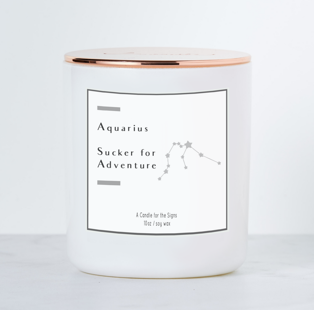 Candle in white glass jar. Black text reads "Aquarious- Sucker for adventure. A candle for the signs. 10 oz soy wax."