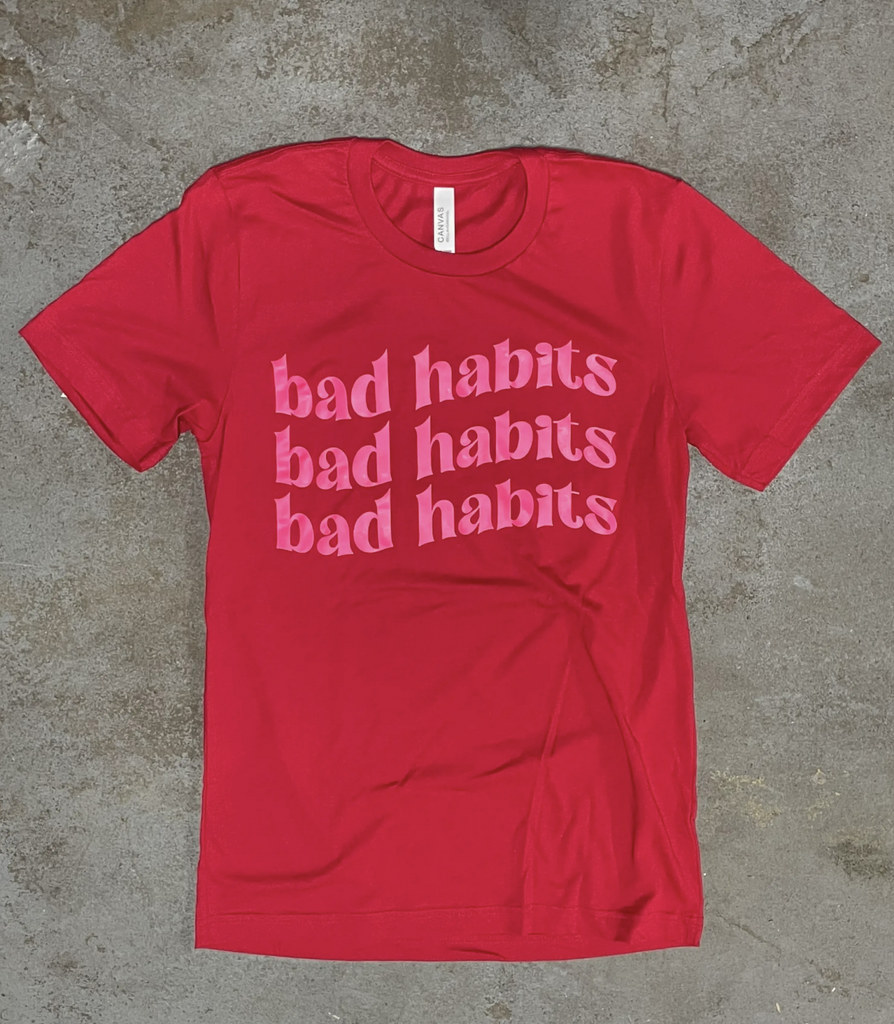 Red shirt that says "bad habits" in pink.