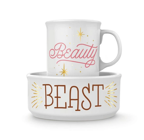 White ceramic bowl that reads BEAST in gold foil and a white ceramic mug that reads BEAUTY in pink.