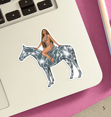Beyonce on an electrified horse die cut vinyl sticker applied to the corner of a lap top. 