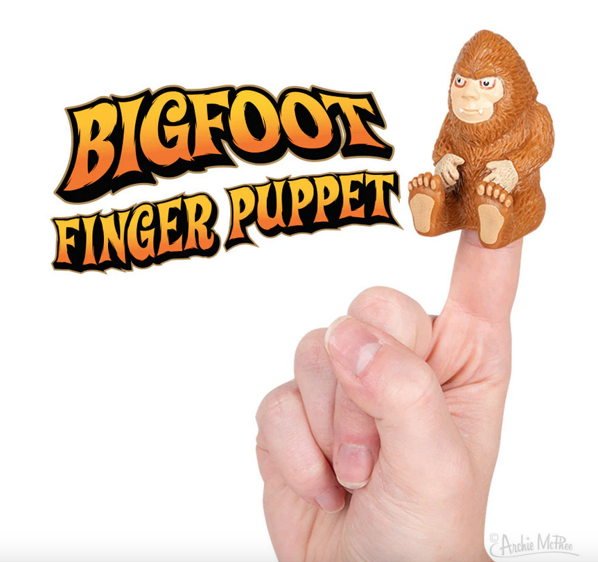 Brown Bigfoot in sitting position finger puppet sitting on a finger. 