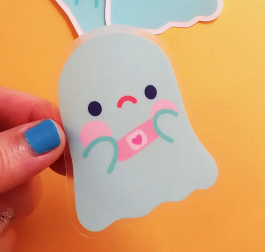 Sticker of a cute sad ghost with a bandage covered boo boo.