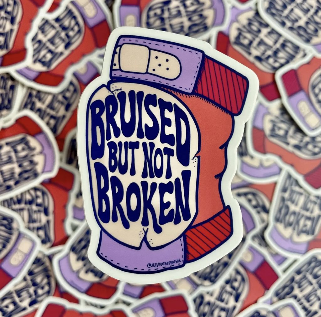 Sticker of a beat up knee pad that reads "Bruised But Not Broken."