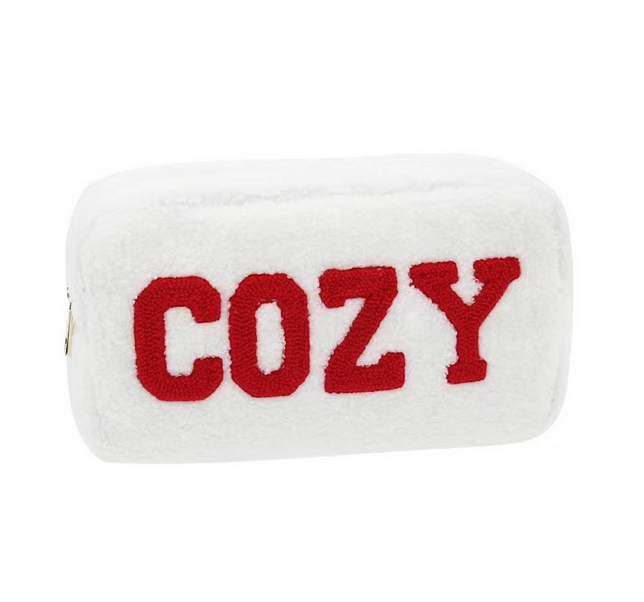 COZY spelled out in soft red chenille letters on a soft white bag with a bright gold zipper.