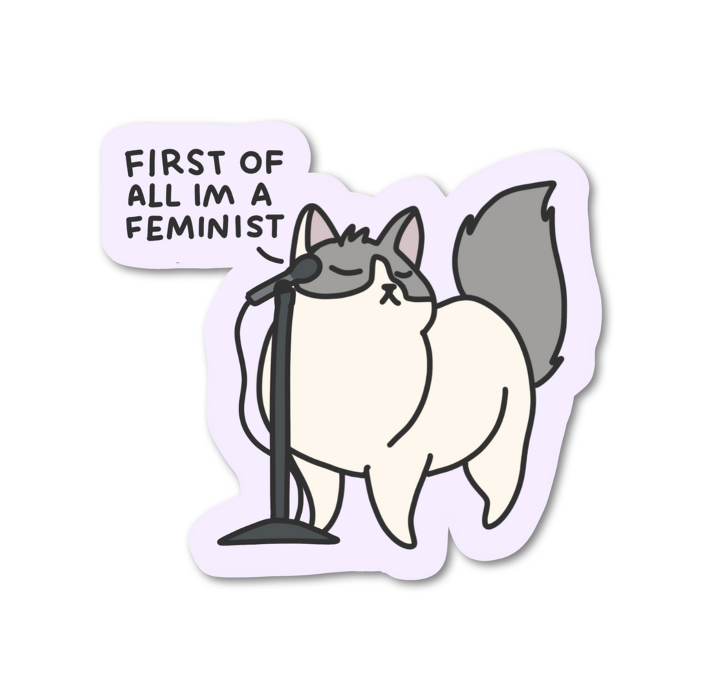 Fluffy white and grey cat standing in front of a microphone stand saying First of all I'm a Feminist sticker.
