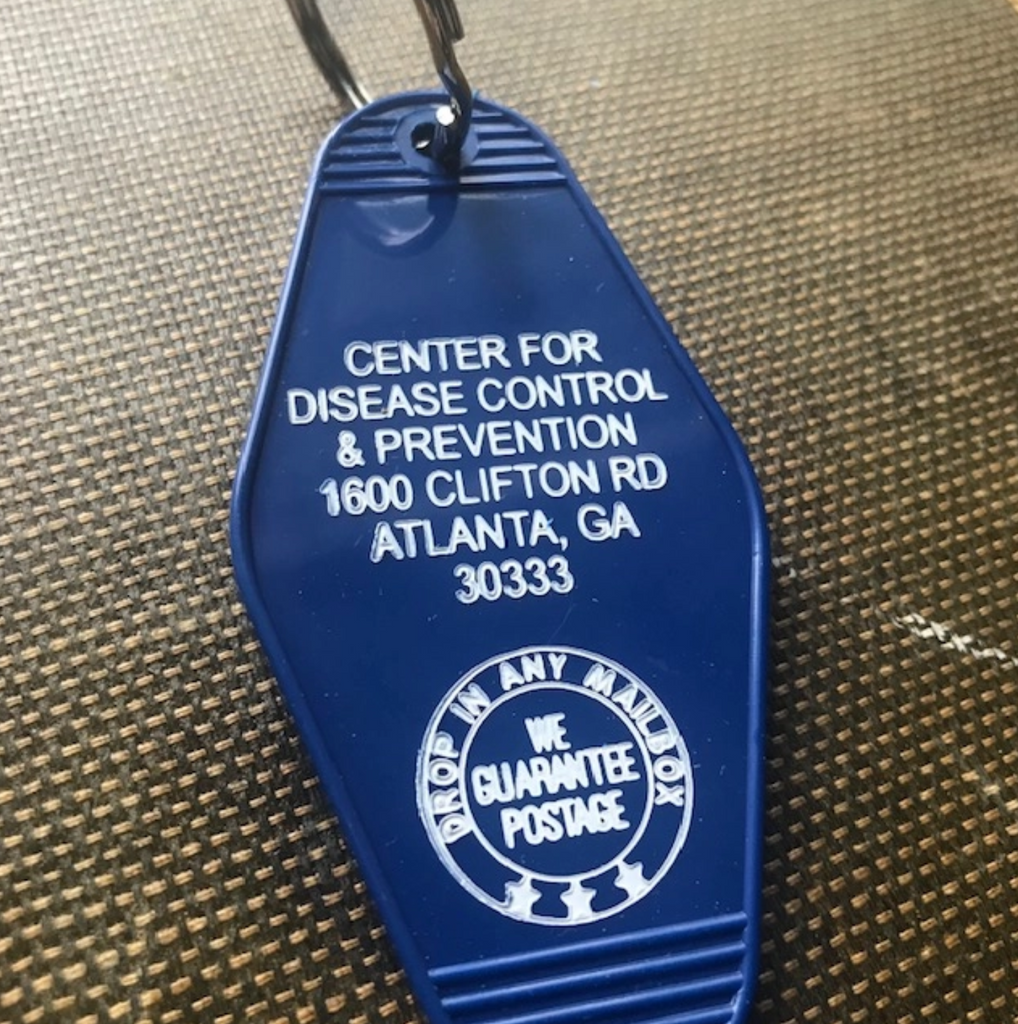 Blue motel style key with white text that reads Center for Disease Control & Prevention 1600 Clifton Rd Atlanta, GA 30333.