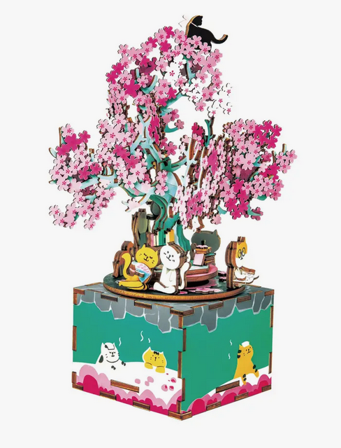 3D Wooden Puzzle Music Box: Cherry Blossom Tree. Assemble wooden puzzle pieces into your own work of art! Each puzzle piece is laser-cut to easily snap out and smoothly interlock for an enjoyable building experience. No additional tools or glue necessary. This beautiful music box starts to spin as it plays the tune, "Green Sleeves" after being wound up.