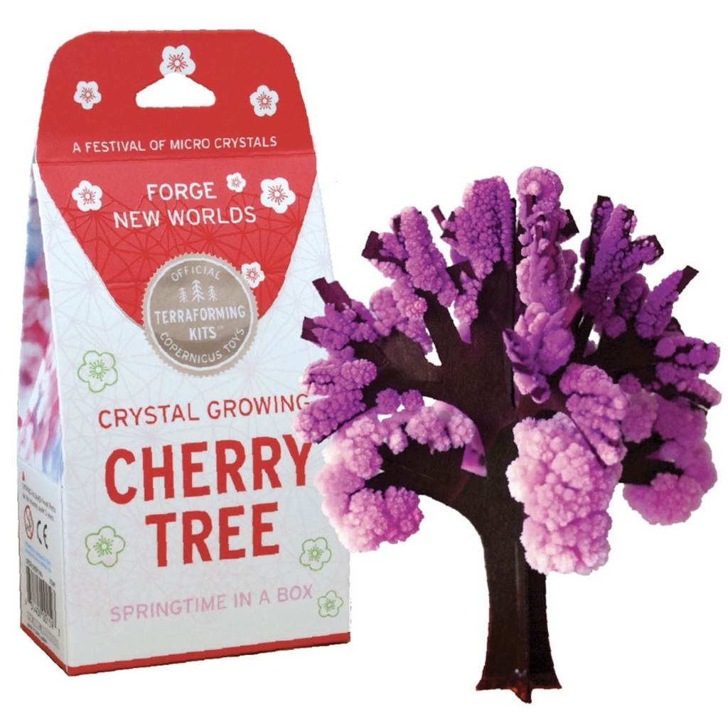 Papper cherry tree with a brown trunk and light pink to purple crystals growing on the branches. The package is white and red with red lettering. 