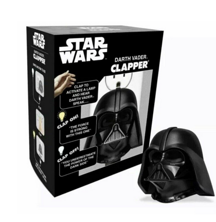 Darth Vader Talking Clapper and box. The Clapper looks like Darth Vaders helmet. The box in the background is black and white with a picture of the clapper on the front. 