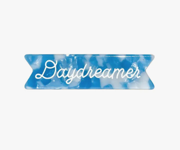 A sweet hair clip for those of us whose heads remain permanently in the clouds. 'Daydreamer' blue and white cloud acetate with white cursive ink inlay and gold mini alligator clip on back. 2 inches wide, 1/2 inch tall.