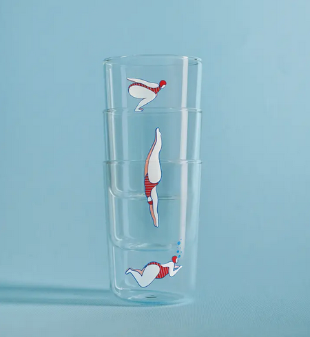 Set of 3 Deep Dive glasses stacked together. Each glass has a graphic of a swimmer in a different position on them. 
