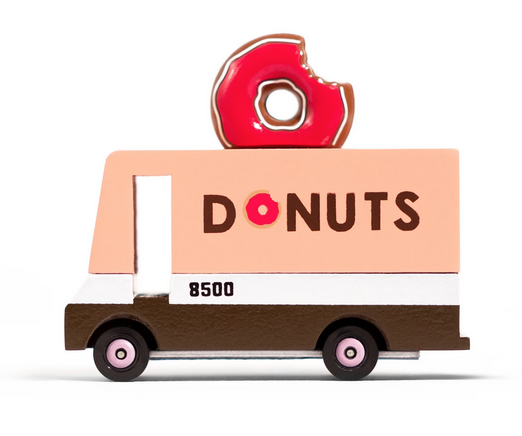 Wooden diecst Donut van food truck. Van has a pink donut on top.