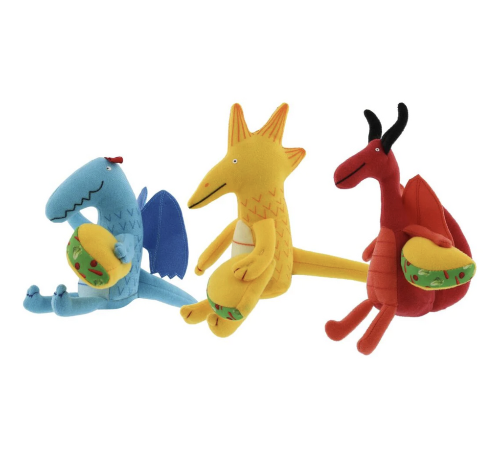 Three mini plush dragons. One blue dragon with wings holding a taco. One yellow dragon with spikes on it's head and an extra long tail holding a taco, and a red dragon with black horns and spiky tail, also holding a taco. 