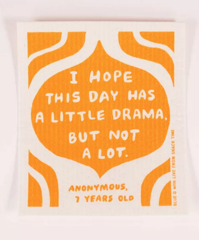 White Swedish dishcloth with orange swirls and an onion shaped bubble that reads "I Hope This Day Has A Little Drama, But Not A Lot" and is credited to Anonymous 7 Years old. 