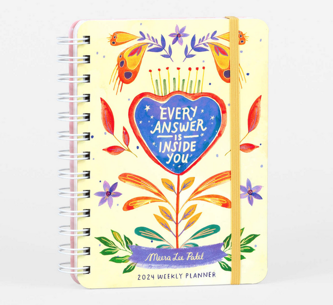 Cover of "Every Answer is Inside You" spiral bound planner with yellow background and floral illustrations. 