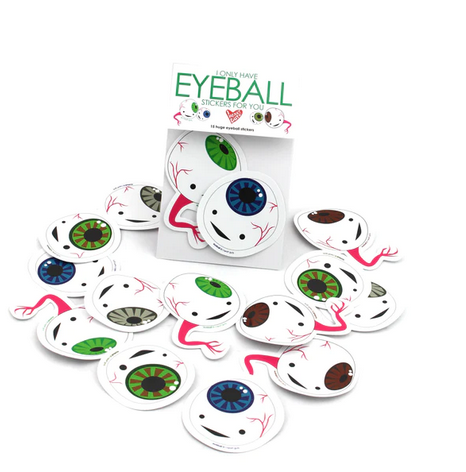 Green, brown, blue and grey eyeball stickers with optic nerve together in a pack as well scattered in front of the package. 