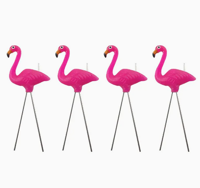 Set of four pink flamingo lawn ornament candles. 