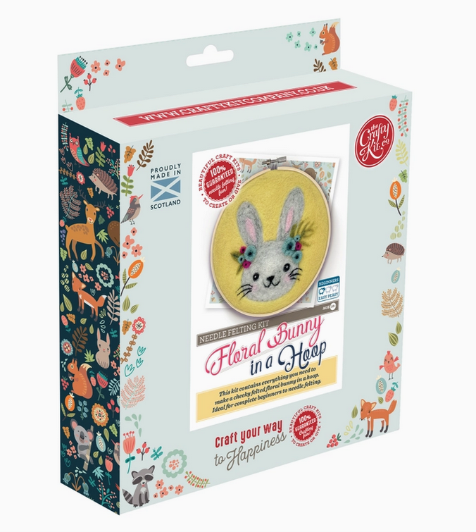 Box for the Floral Bunny in a Hoop Needle Felting Kit. The box has a picture of the completed craft on  the front and illustrations of animals and flowers down the sides of the boxes. 