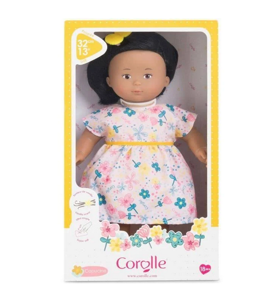 Florolle Capucine is a 13-inch soft body doll. She has silky, rooted brown hair styled in a bob, brown painted eyes and a cheerful smile. Here she is in her box with a clear plastic window. 