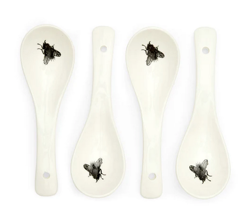 White ceramic spoon set with black flies on mouth piece.