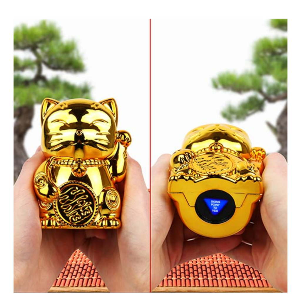 Metallic gold Fortune Kitty being held. Shows an answer to a question in the hole in the bottom of the kitty.