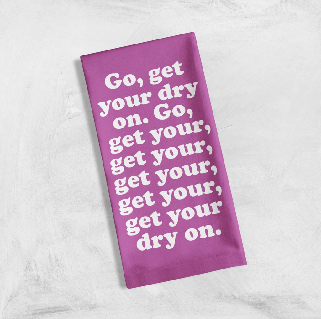 Get Your dry on dish towel is bright purple with white lyrics about cleaning loosely based on a Missy Elliott song.