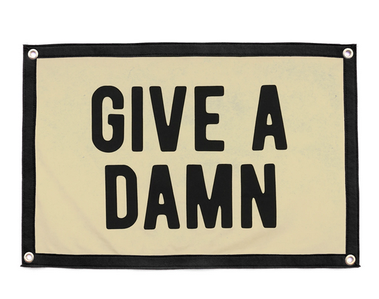 Cream and navy blue flag that reads "Give A Damn" in blue.