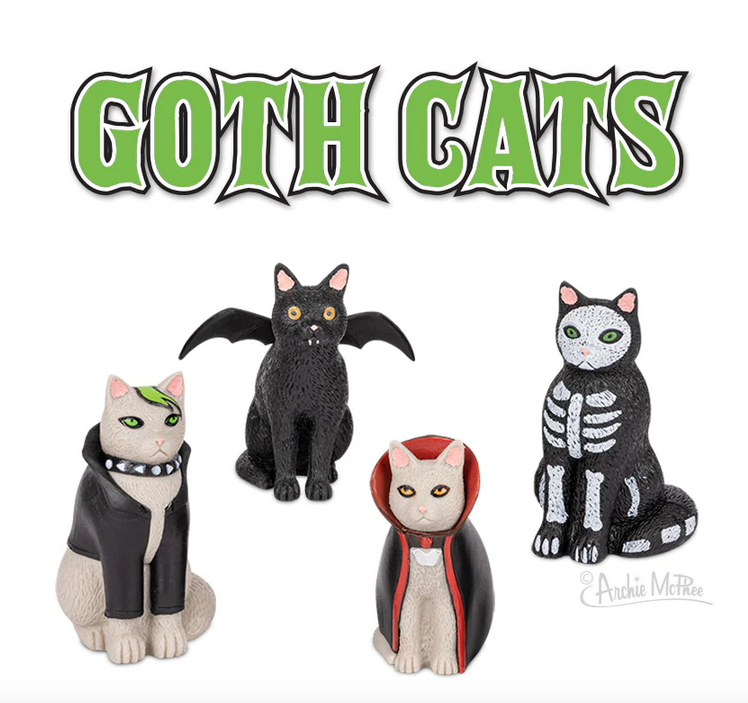 Assortment of four soft vinyl Goth Cats. A black cat as a bat, a cat as a skeleton, a dracula cat in a cape, and a white cat with green hair and leather jacket. 