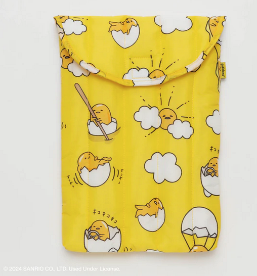 Puffy yellow lap top sleeve with Gudetama in an egg car, egg boat with oar and lazing in a cracked egg.  