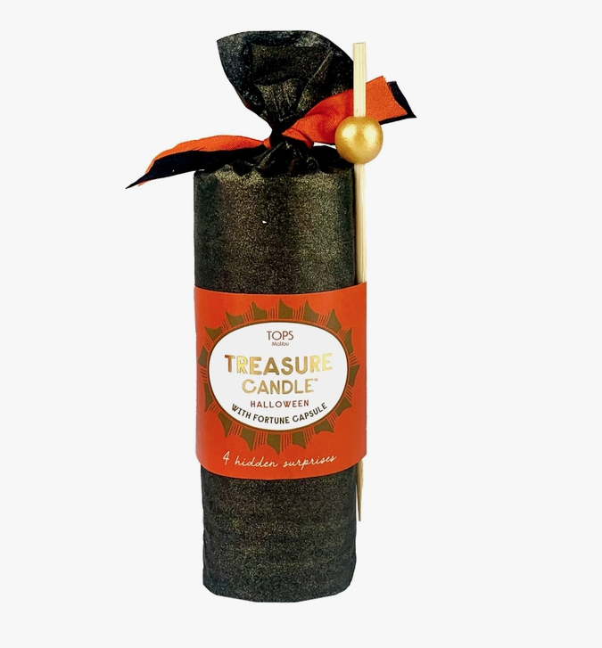 Candle wrapped in black crepe paper with an orange banner and ribbon at the top. 