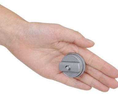 Classic hand buzzer prank shown in use in the palm of a hand. Buzzer is made of gray plastic. 
