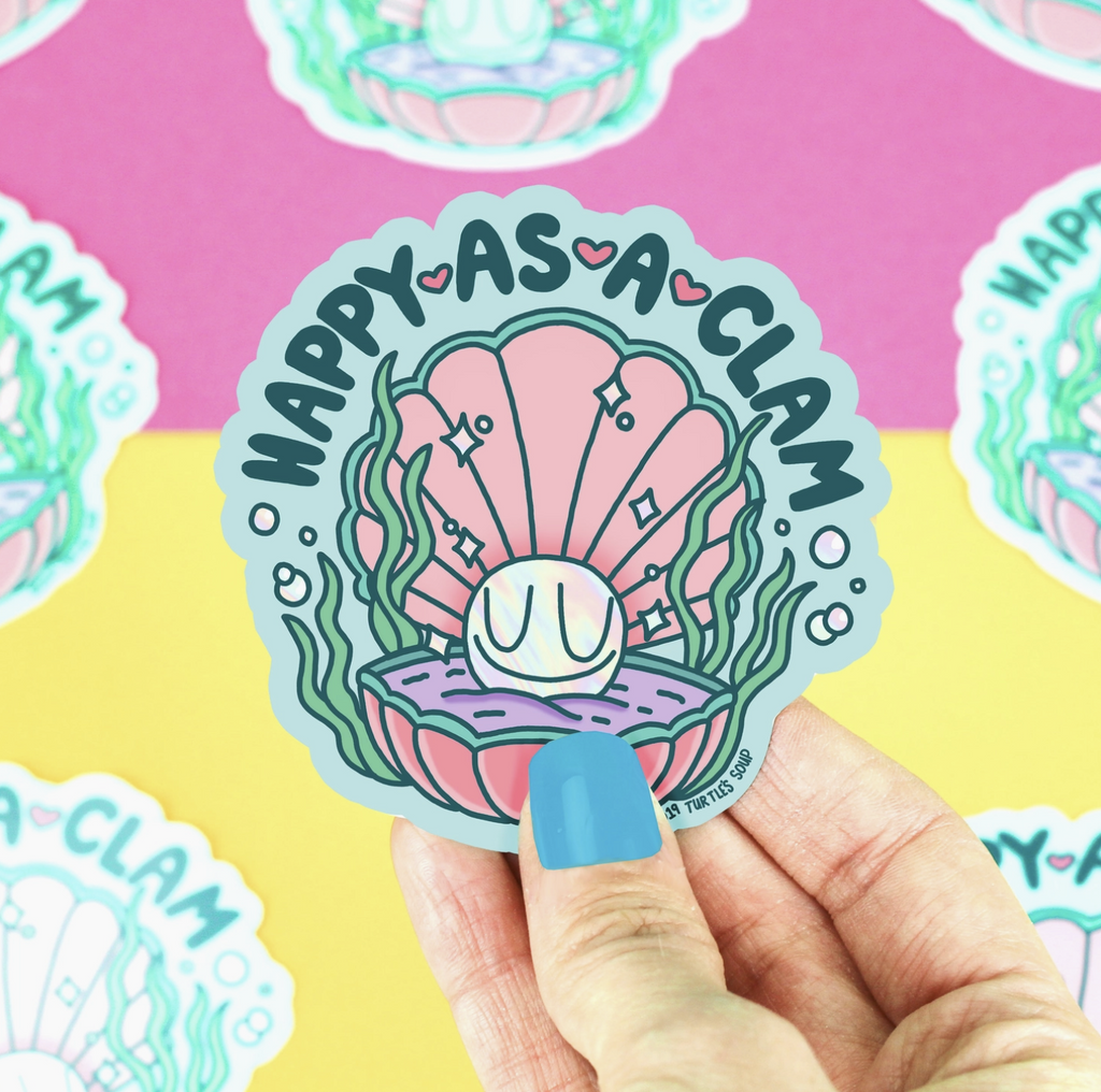Diecut sticker of an open clam shell with a happy faced pearl inside. Text reads "Happy As a Clam."