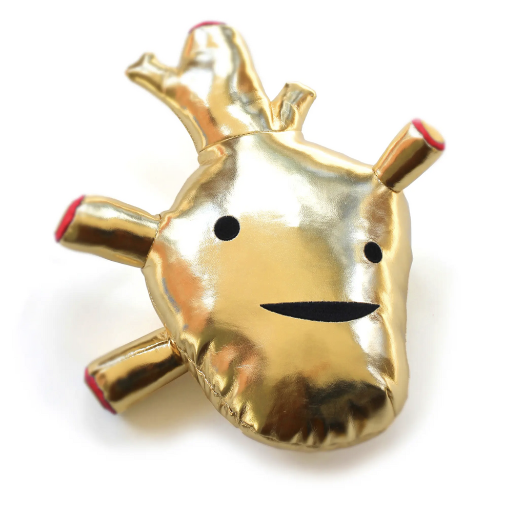 Gold metallic anatomical heart plush with eyes and a smilng mouth. 