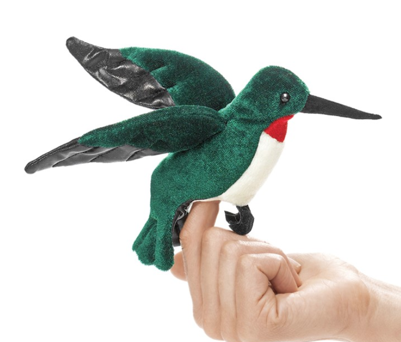 Bright green hummingbird finger puppet with red and white chest perched on a finger. 