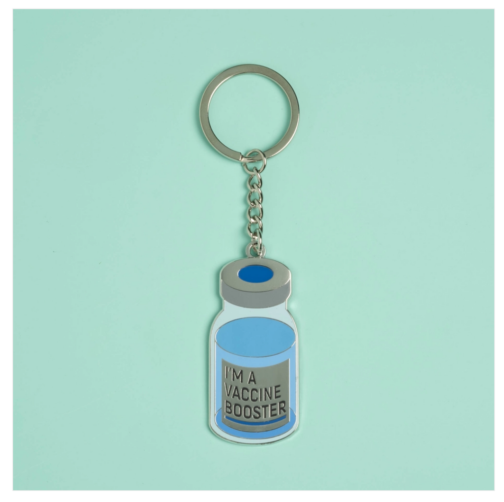 Metal Keychain with a flat metal vaccine bottle that reads I'm a vaccine booster.